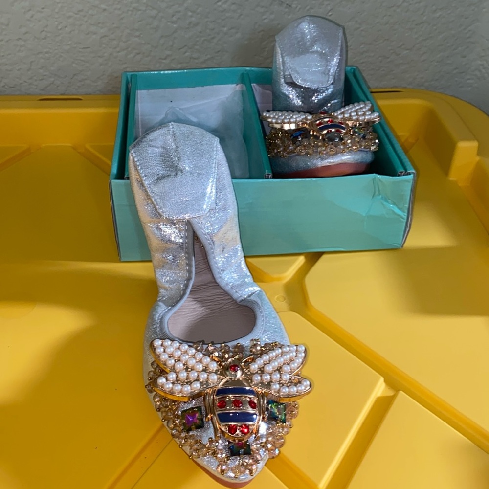 Woman’s foldable flat silver shoes